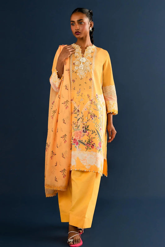 Model wearing yellow embroidered Pakistani lawn clothing for summer.