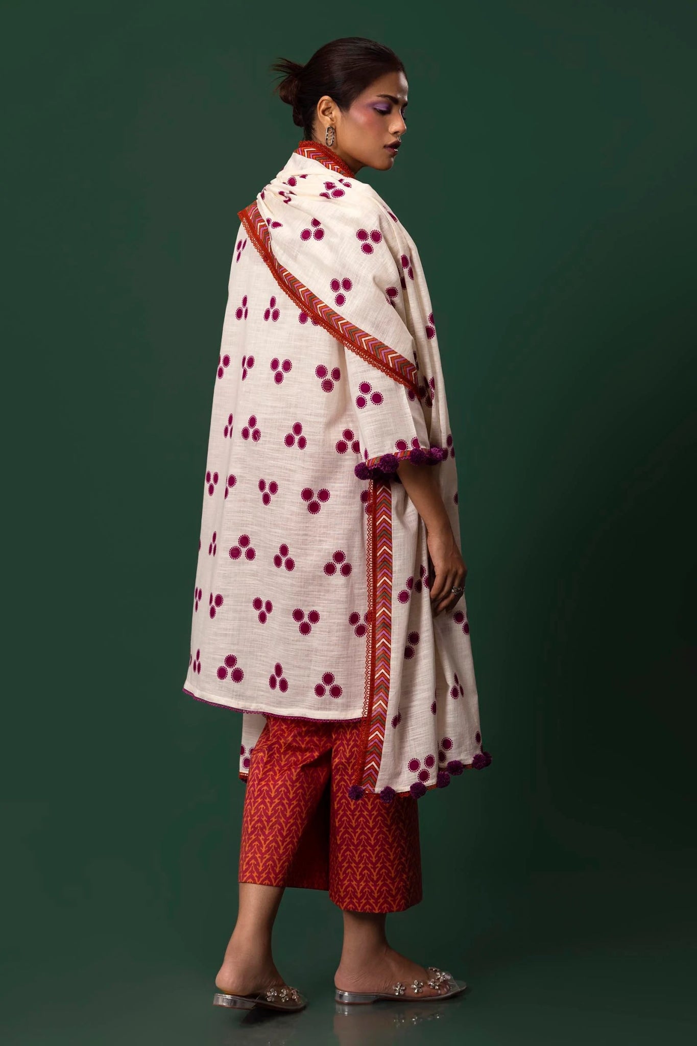 Model wearing Sana Safinaz Mahay Winter '24 H243 - 001A - 3CQ, showcasing a white and orange 3 - piece outfit with embroidery and intricate printing, ideal for winter casual pret. Available online in the UK.