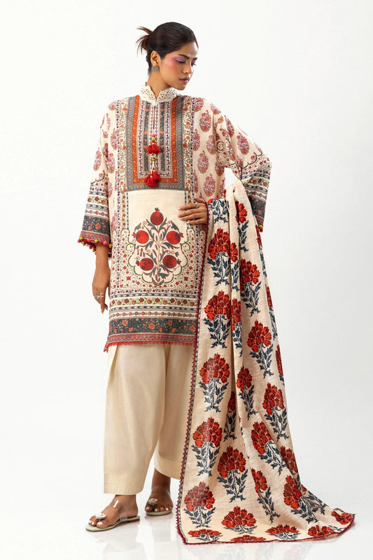 Model wearing Sana Safinaz Mahay Winter '24, showcasing a white and orange 2 - piece outfit with embroidery and intricate printing, ideal for winter casual pret. Available online in the UK.