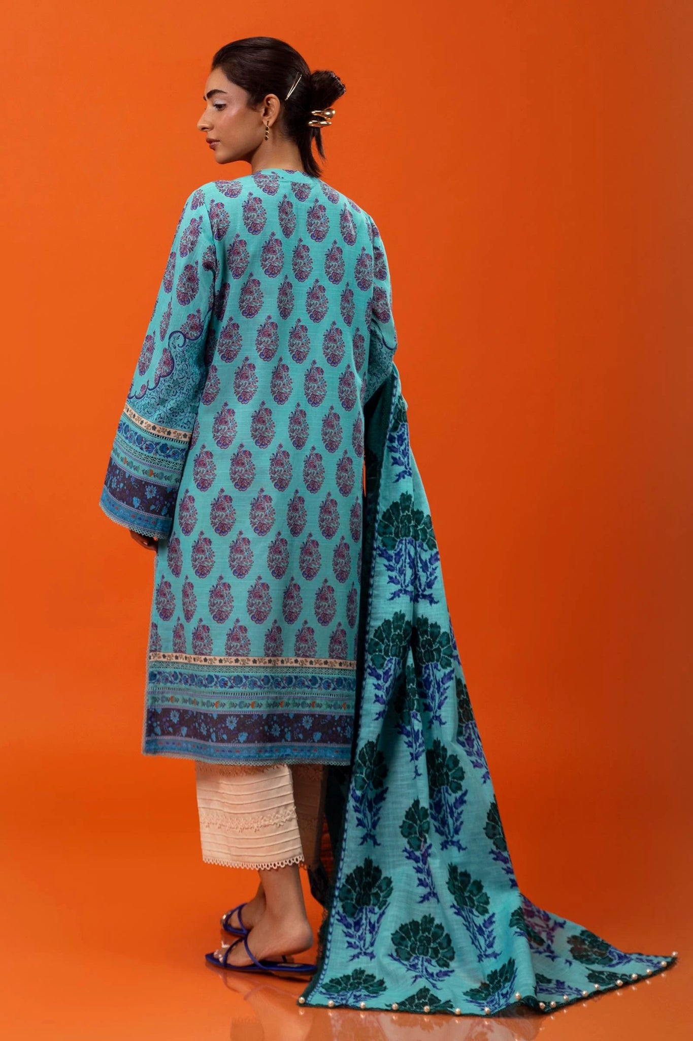 Model wearing Sana Safinaz Mahay Winter '24, showcasing a blue 2 - piece outfit with intricate printing om khaddar, ideal for winter casual pret. Available online in the UK.