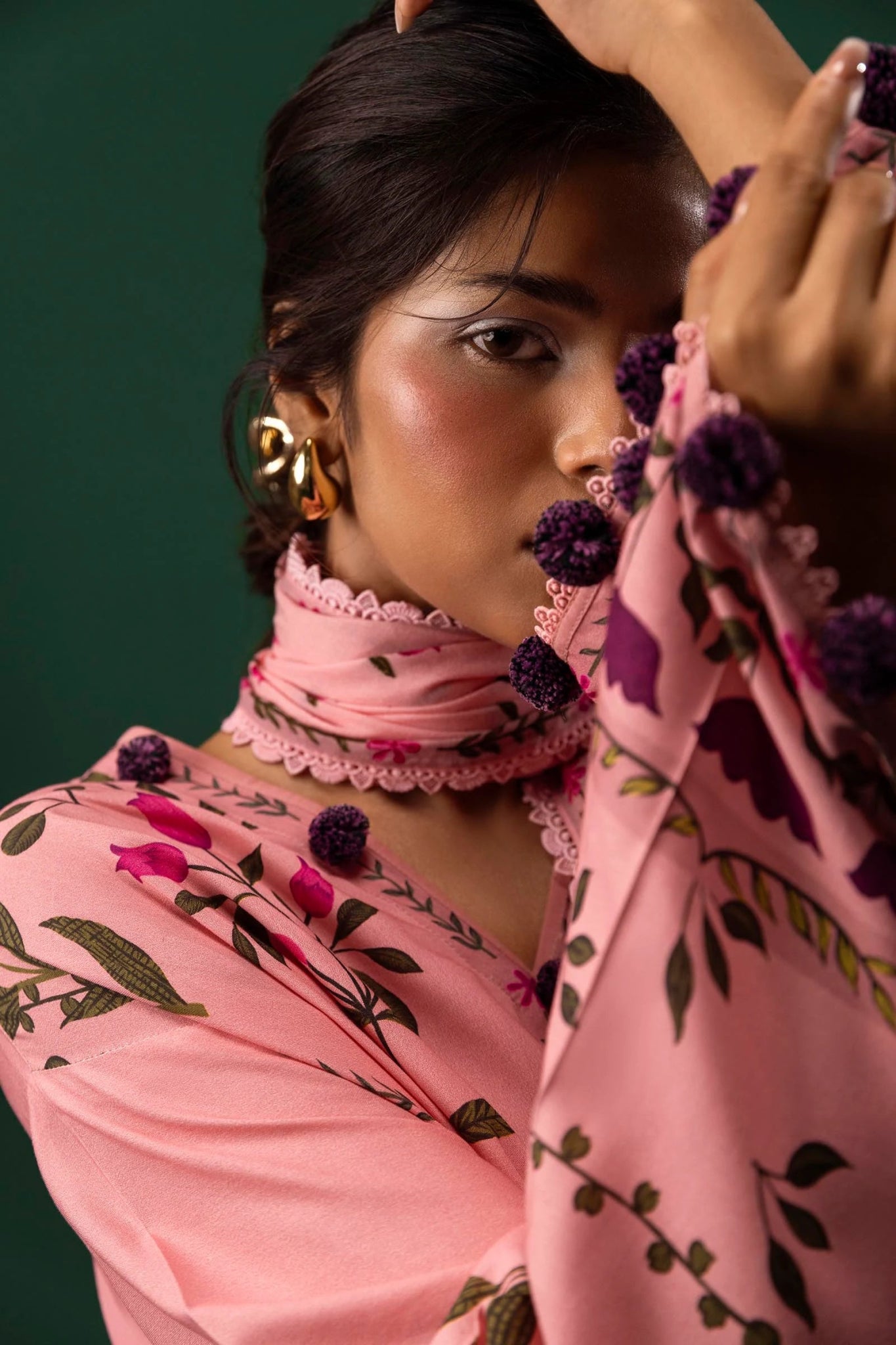 Model wearing a three - piece Sana Safinaz suit from Mahay Winter '24 in pink, featuring digital prints on linen, a printed dupatta, and dyed cambric pants. Available online in the UK.