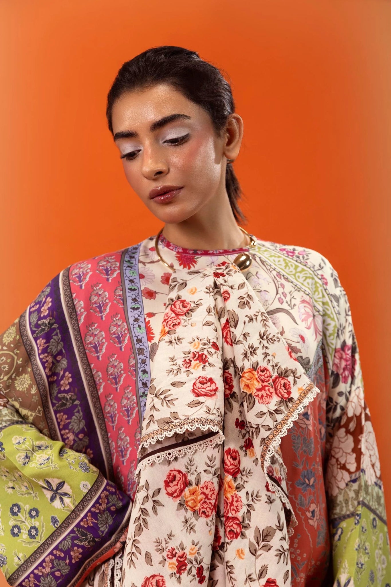 Model wearing a two - piece Sana Safinaz suit from Mahay Winter '24 featuring a digitally printed linen shirt with vibrant floral and geometric patterns, paired with a coordinating rotary printed linen dupatta. Available online in the UK.