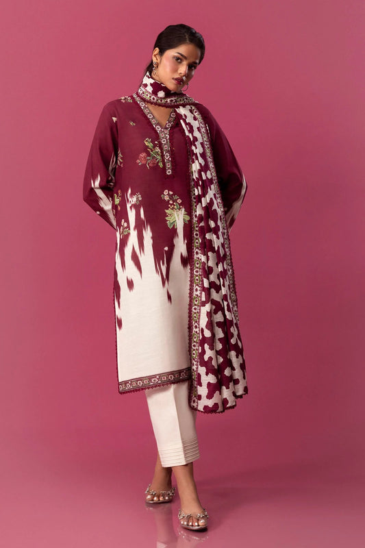 A model displays a two - piece Sana Safinaz suit from the Mahay Winter collection. This elegant ensemble features a digitally printed slub shirt with intricate floral patterns on the front, back, and sleeves, complemented by an embroidered patti on organza for a refined finish. Paired with a contrasting khaddar dupatta adorned with rotary prints, this outfit offers a chic, traditional look for women seeking Pakistani designer wear. Available in UK.