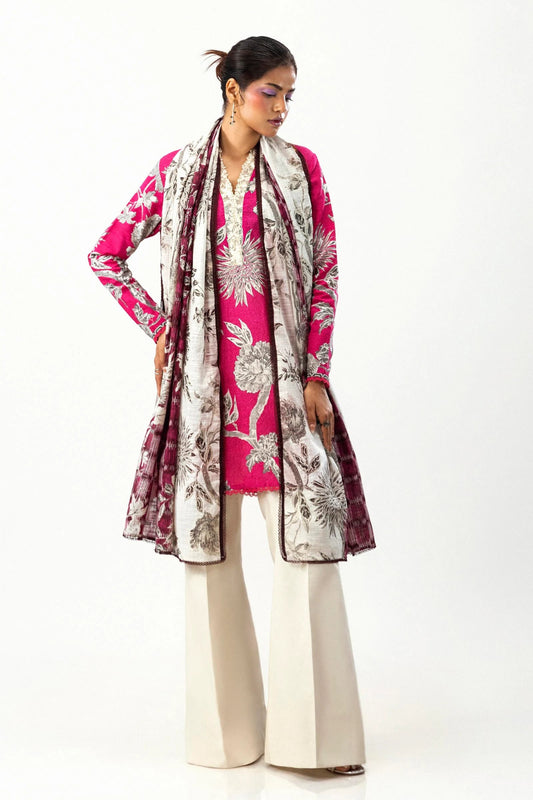 Model wearing a vibrant two - piece outfit from the Mahay Winter '24 collection by Sana Safinaz. The ensemble features a pink digitally printed slub shirt with floral patterns on the front, back, and sleeves, detailed with an embroidered organza patti. Paired with a contrasting khaddar dupatta showcasing intricate rotary prints. Available online for women in the UK.