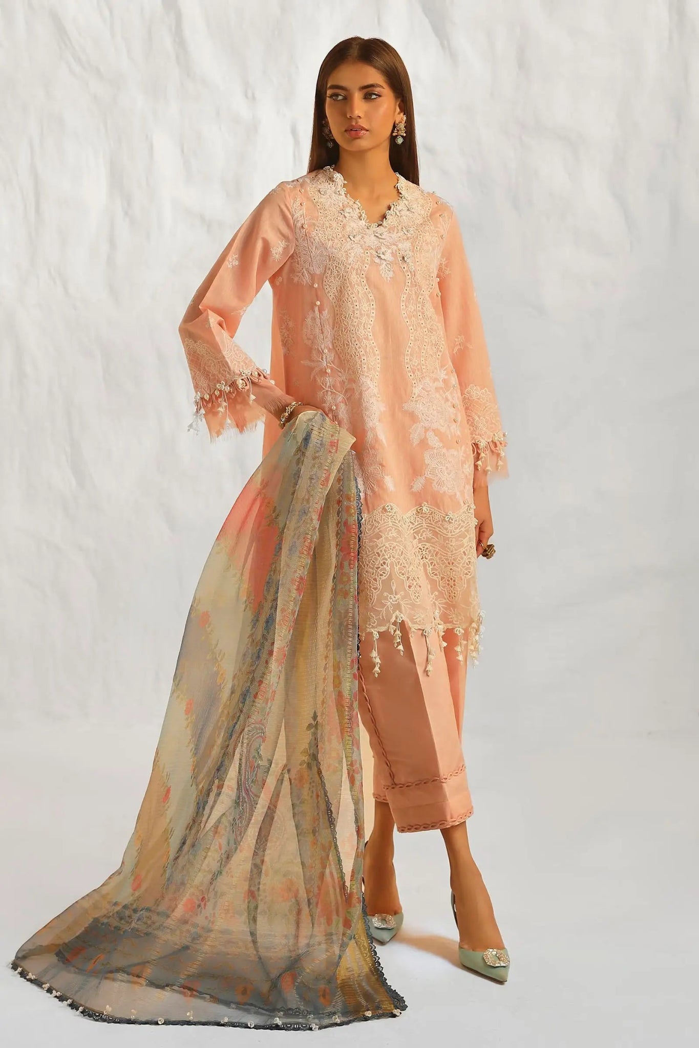 Model wearing Sana Safinaz M242 - 013A - DH peach dress with lace detailing and floral scarf, perfect for elegant Pakistani lawn suits in the UK.