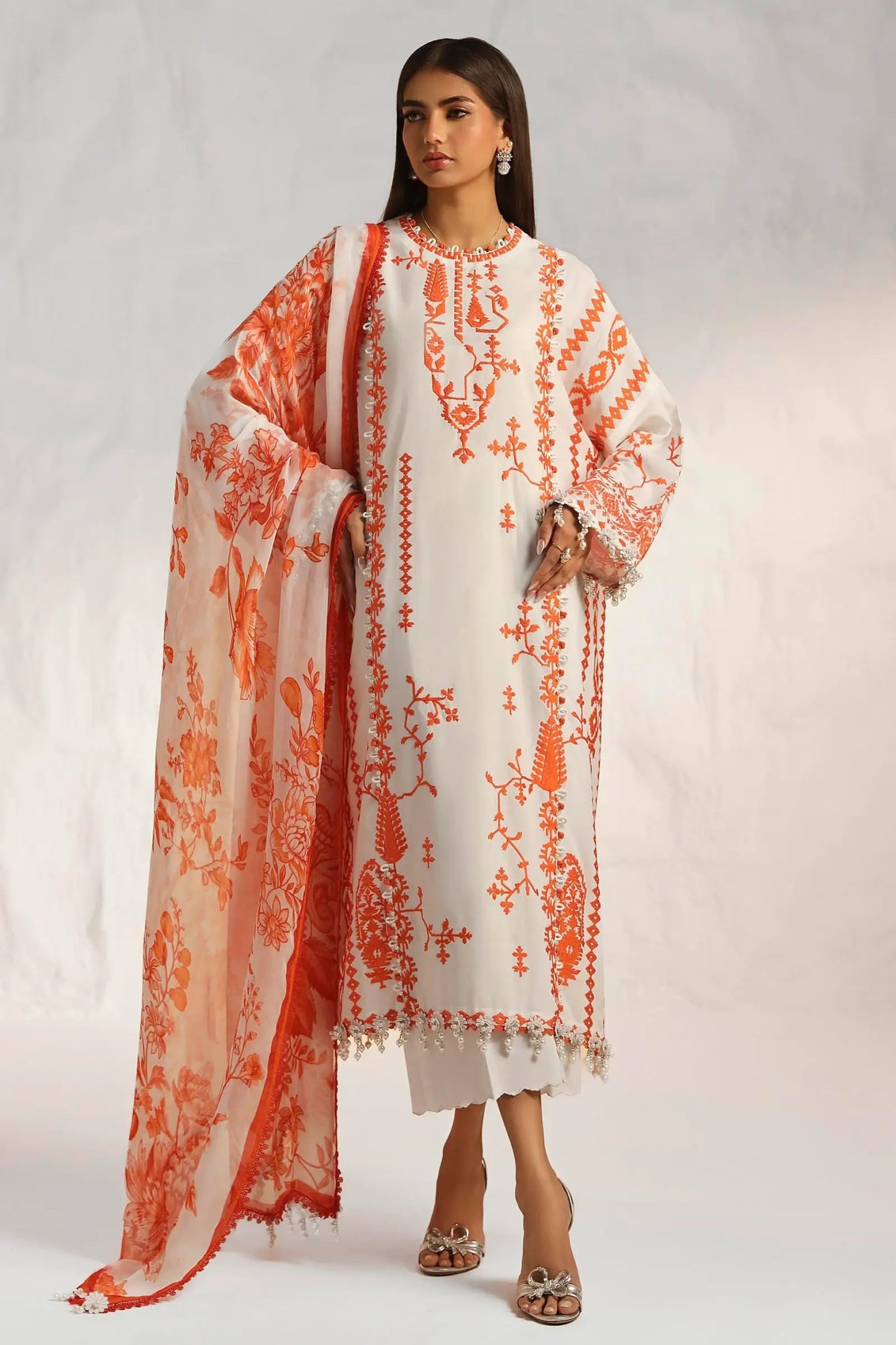 Model wearing Sana Safinaz M242 - 017B - CJ off - white dress with vibrant orange embroidery, perfect for Pakistani designer lawn suits in the UK.