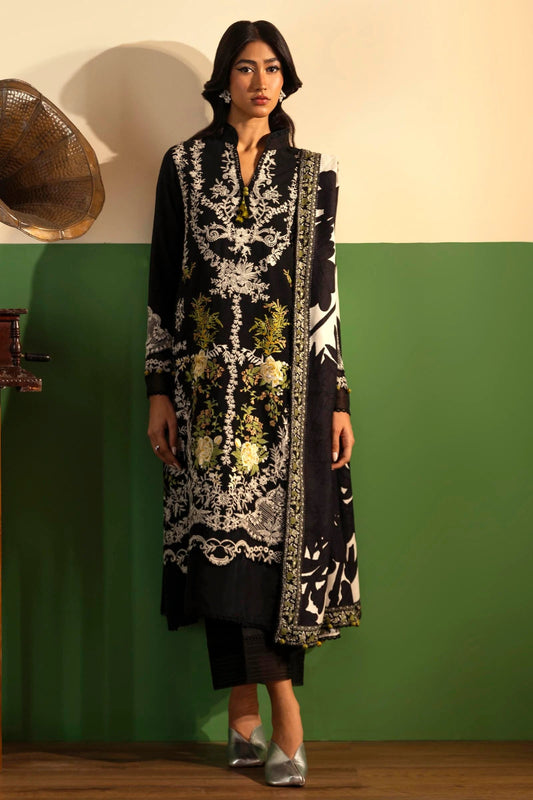 Model wearing a 3 - piece black embroidered suit featuring a slub front kali, embroidered organza sleeves, and a printed shawl with monochrome accents. Paired with dyed cotton pants for a bold look. Part of the Sana Safinaz Muzlin Winter 2024 collection, available online in the UK.