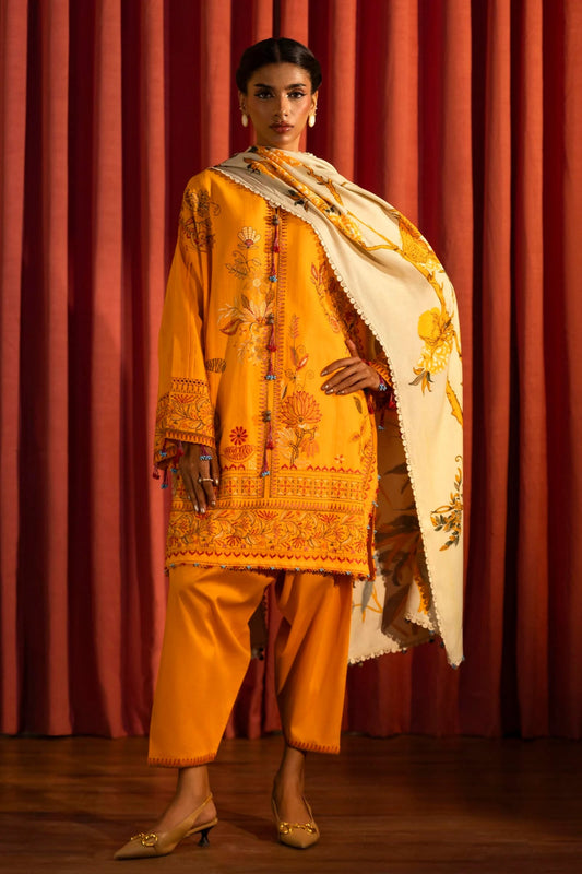 Model wearing a 3 - piece bright orange embroidered suit featuring a slub front kali, embroidered sleeves, and a printed shawl with floral accents. Paired with dyed cotton pants for a vibrant look. Part of the Sana Safinaz Muzlin Winter 2024 collection, available online in the UK.