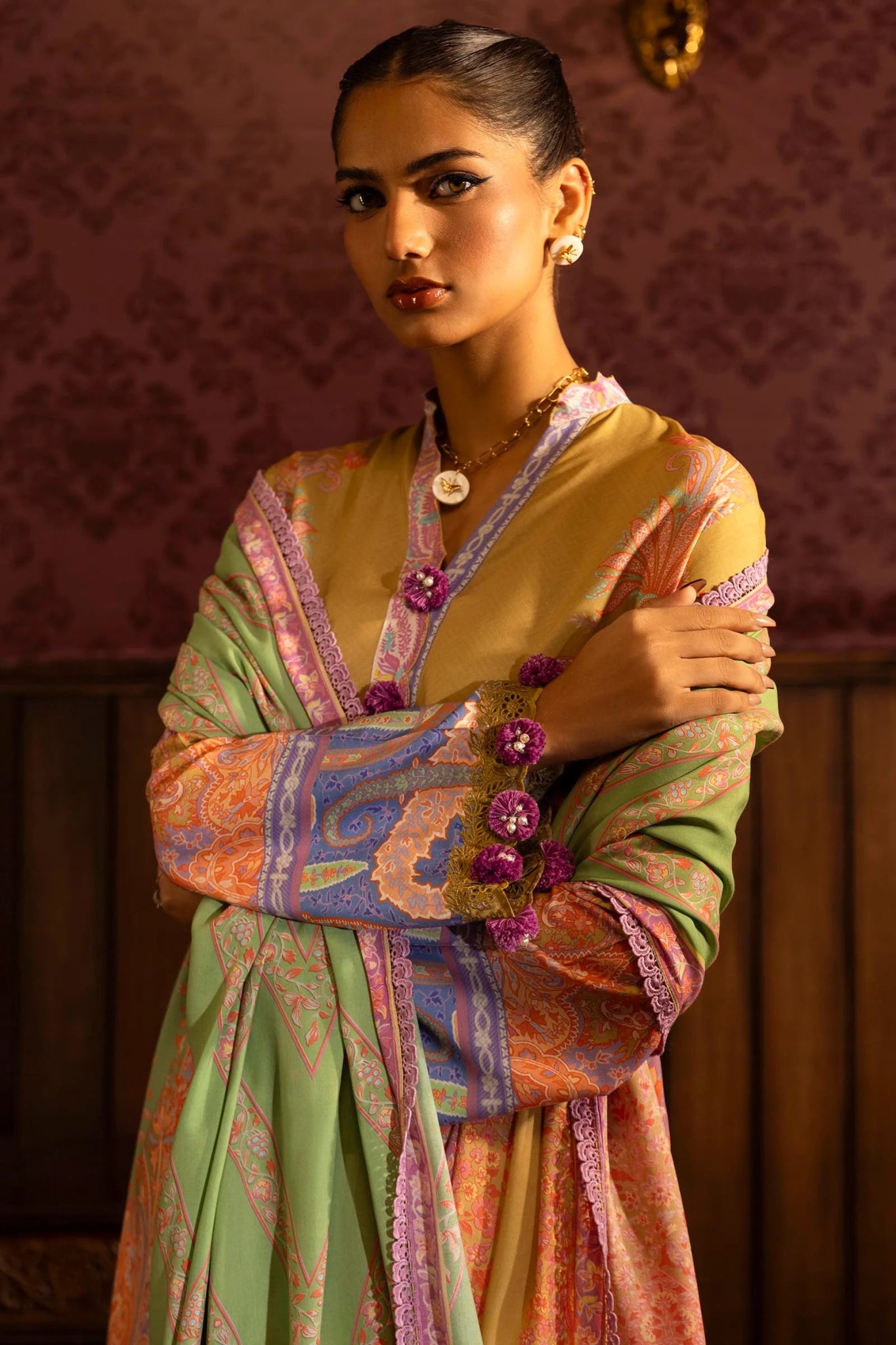 Model wearing a 3 - piece vibrant yellow suit featuring a digitally printed linen front, back, and sleeves, paired with a colorful printed dupatta. Styled with dyed cotton pants for a bold look. Part of the Sana Safinaz Muzlin Winter 2024 collection, available online in the UK.