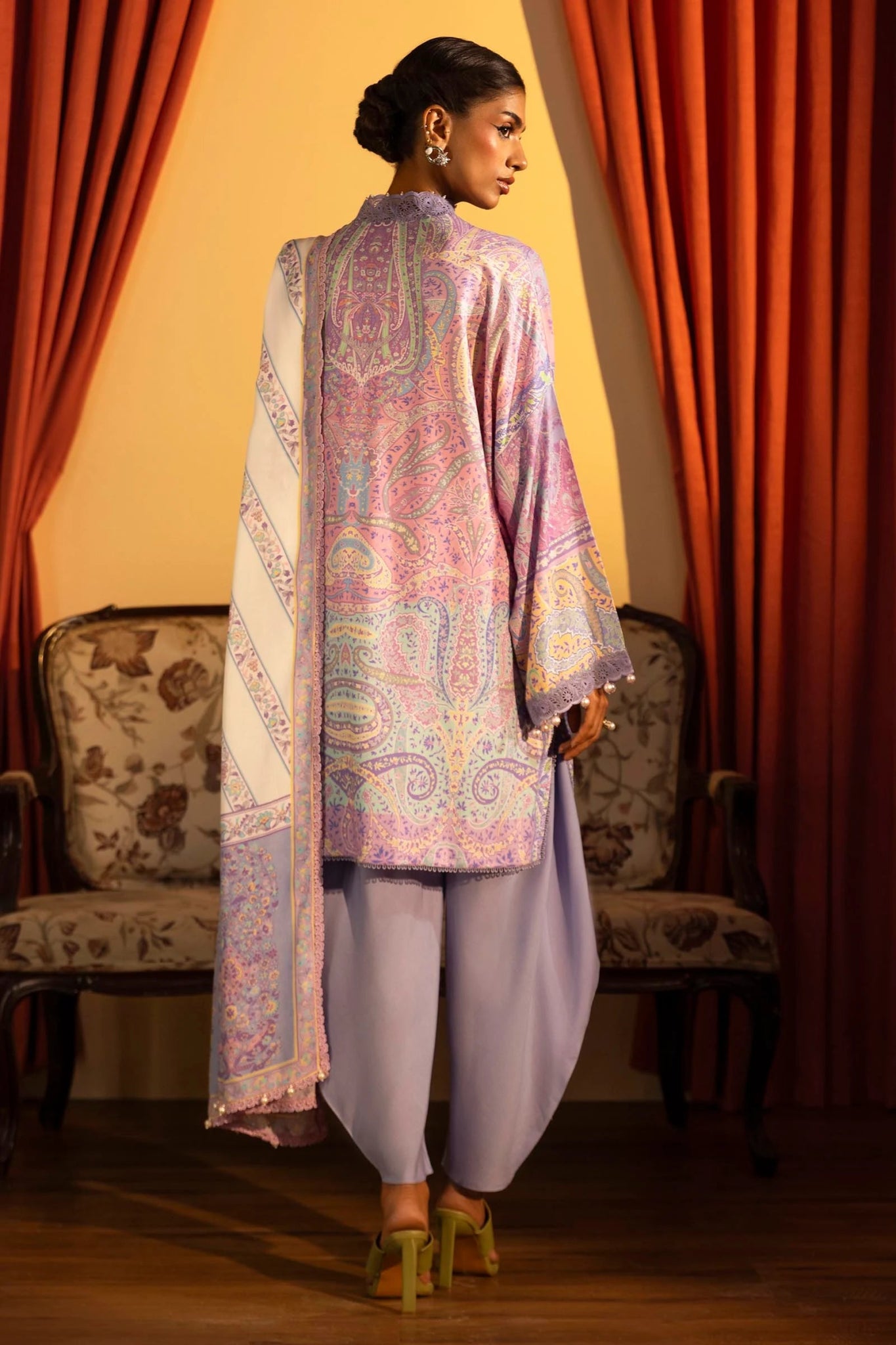 Model wearing a 3 - piece lavender suit featuring a digitally printed linen front, back, and sleeves with intricate patterns, paired with a matching printed dupatta. Styled with dyed cotton pants for an elegant look. Part of the Sana Safinaz Muzlin Winter 2024 collection, available online in the UK.