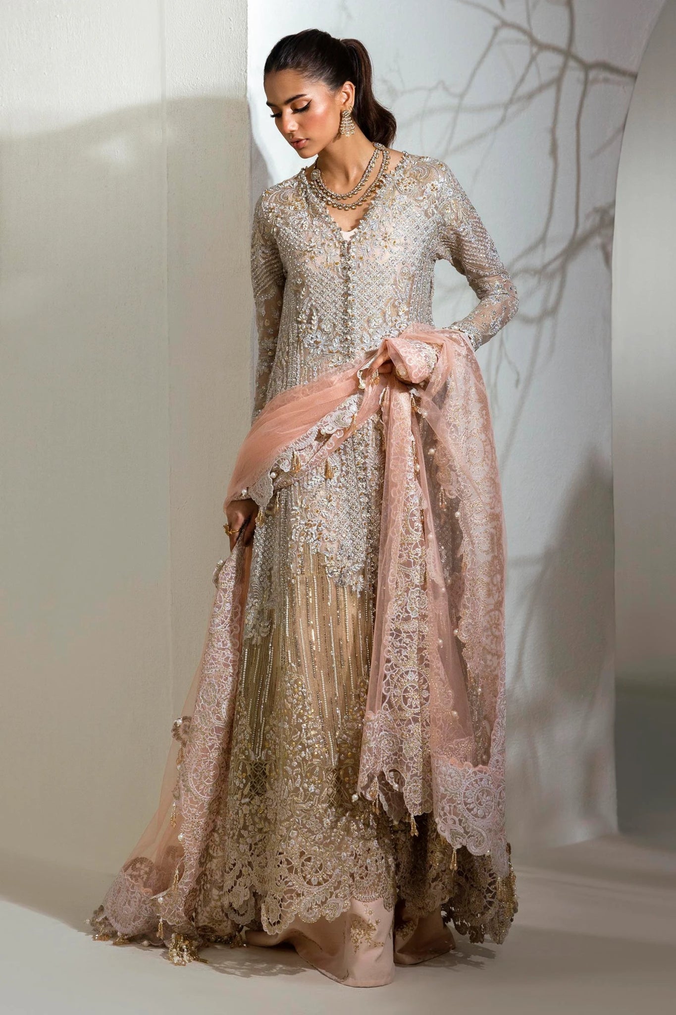 Model wearing Sana Safinaz NURA Festive'24 Vol. II N242 - 003 - 3CT dress in a stunning beige and pink color combination. Perfect for weddings, available online in the UK.