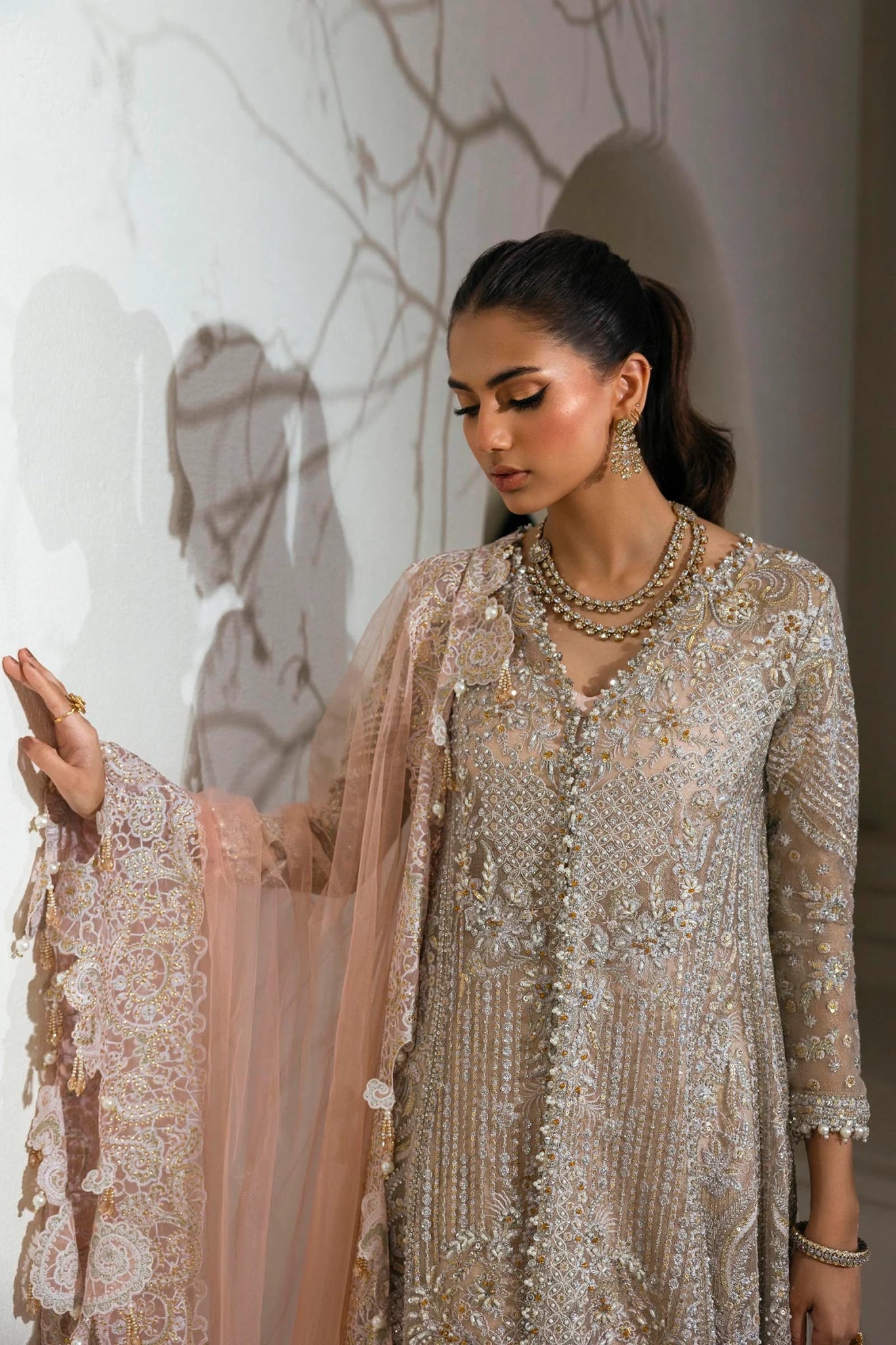 Model wearing Sana Safinaz NURA Festive'24 Vol. II N242 - 003 - 3CT dress in a stunning beige and pink color combination. Perfect for weddings, available online in the UK.