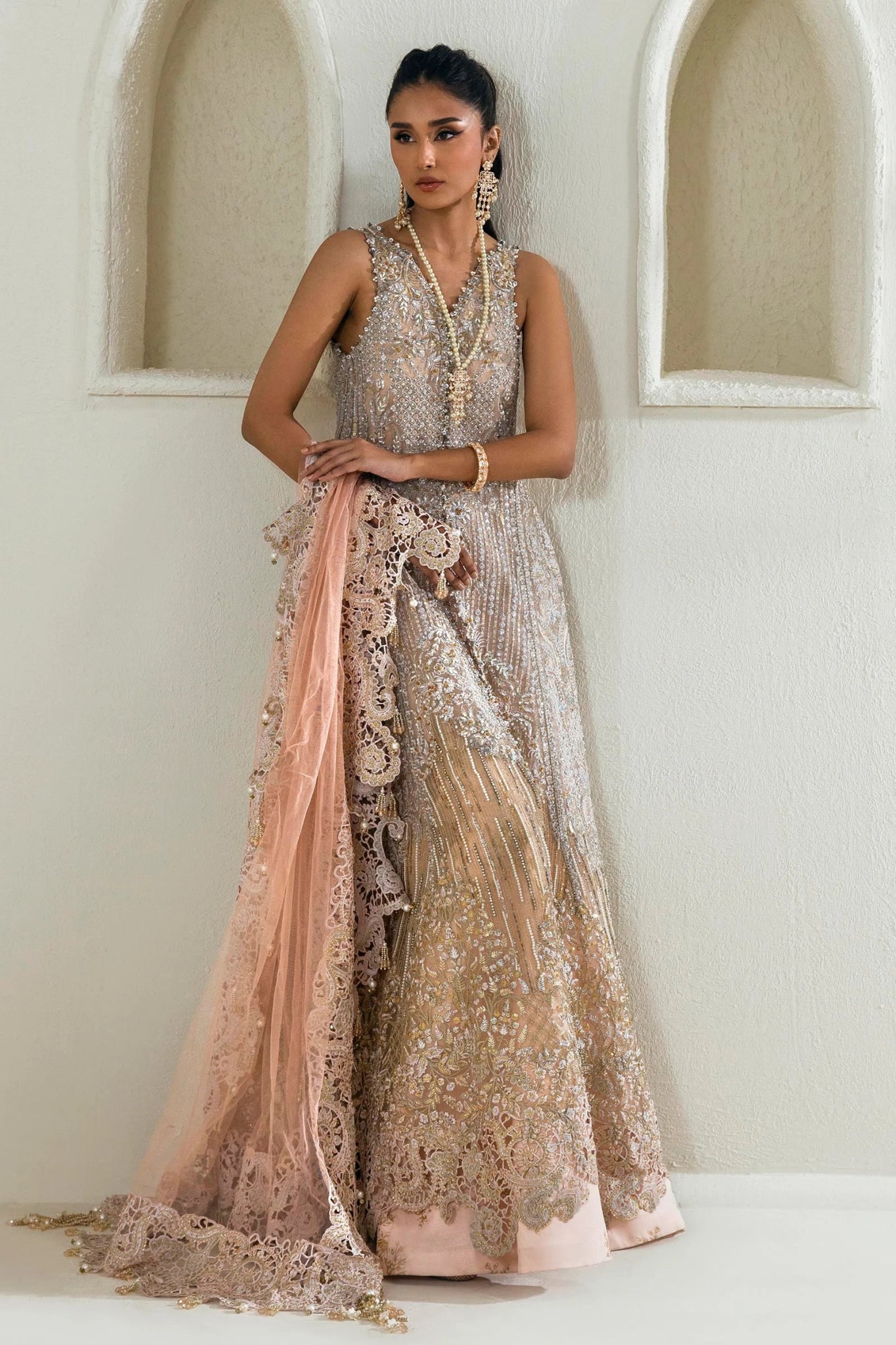 Model wearing Sana Safinaz NURA Festive'24 Vol. II N242 - 003 - 3CT dress in a stunning beige and pink color combination. Perfect for weddings, available online in the UK.