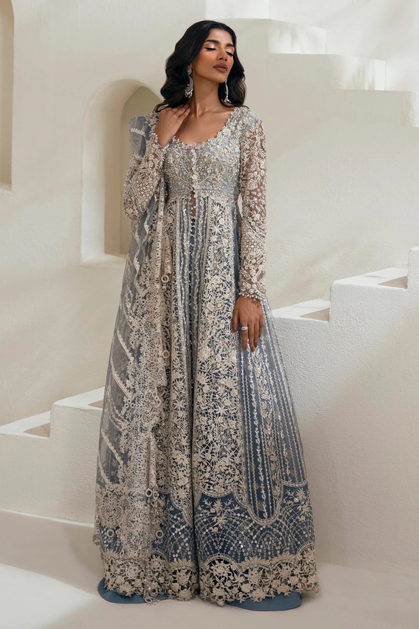 Model wearing N242 - 004 - 3CT dress from Sana Safinaz in a stunning blue color with intricate silver embroidery. Pakistani wedding clothes, available online in the UK.