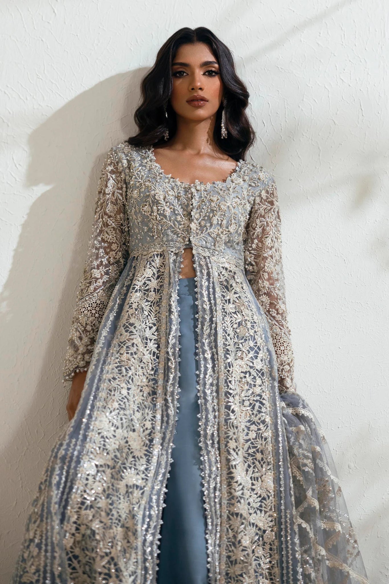 Model wearing N242 - 004 - 3CT dress from Sana Safinaz in a stunning blue color with intricate silver embroidery. Pakistani wedding clothes, available online in the UK.