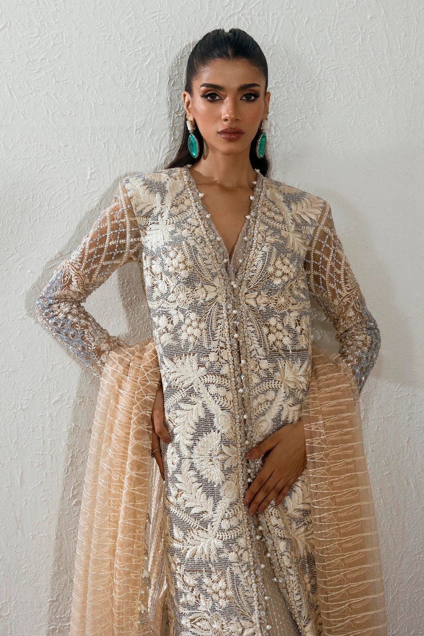 Model wearing an elegant N242 - 005 - 3CT dress in beige and gold from Sana Safinaz's NURA Festive '24 Vol. II collection. Available for Pakistani clothes online in UK, perfect for wedding clothes.