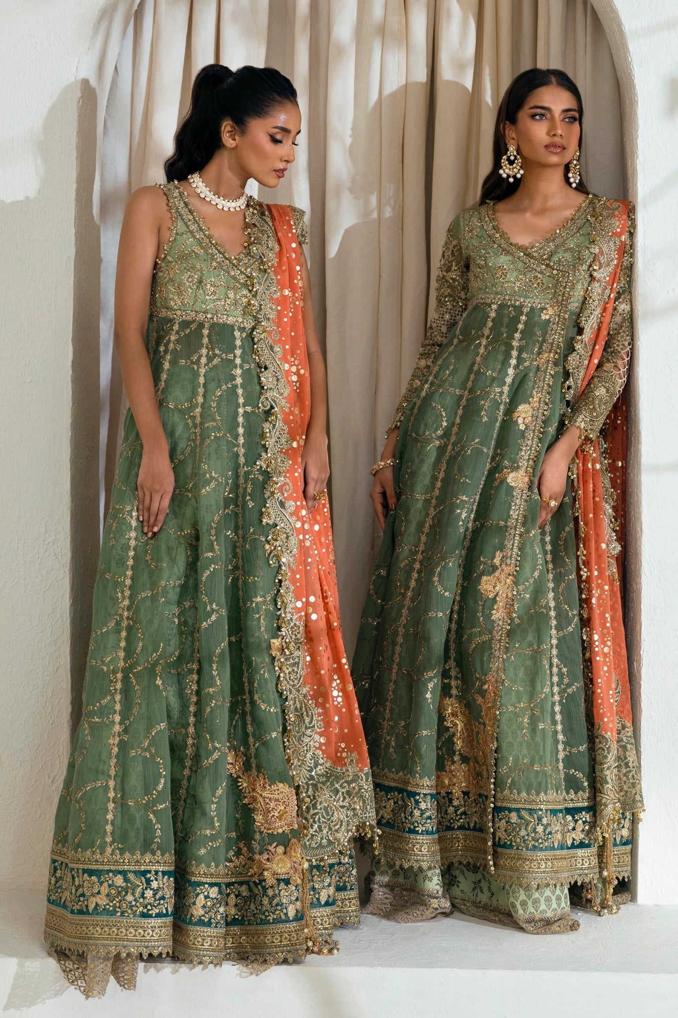 Model wearing Sana Safinaz NURA Festive'24 Vol. II N242 - 006 - 3CX dress, featuring a green ensemble with gold embellishments and an orange dupatta. Perfect for weddings and available as Pakistani clothes online in the UK.