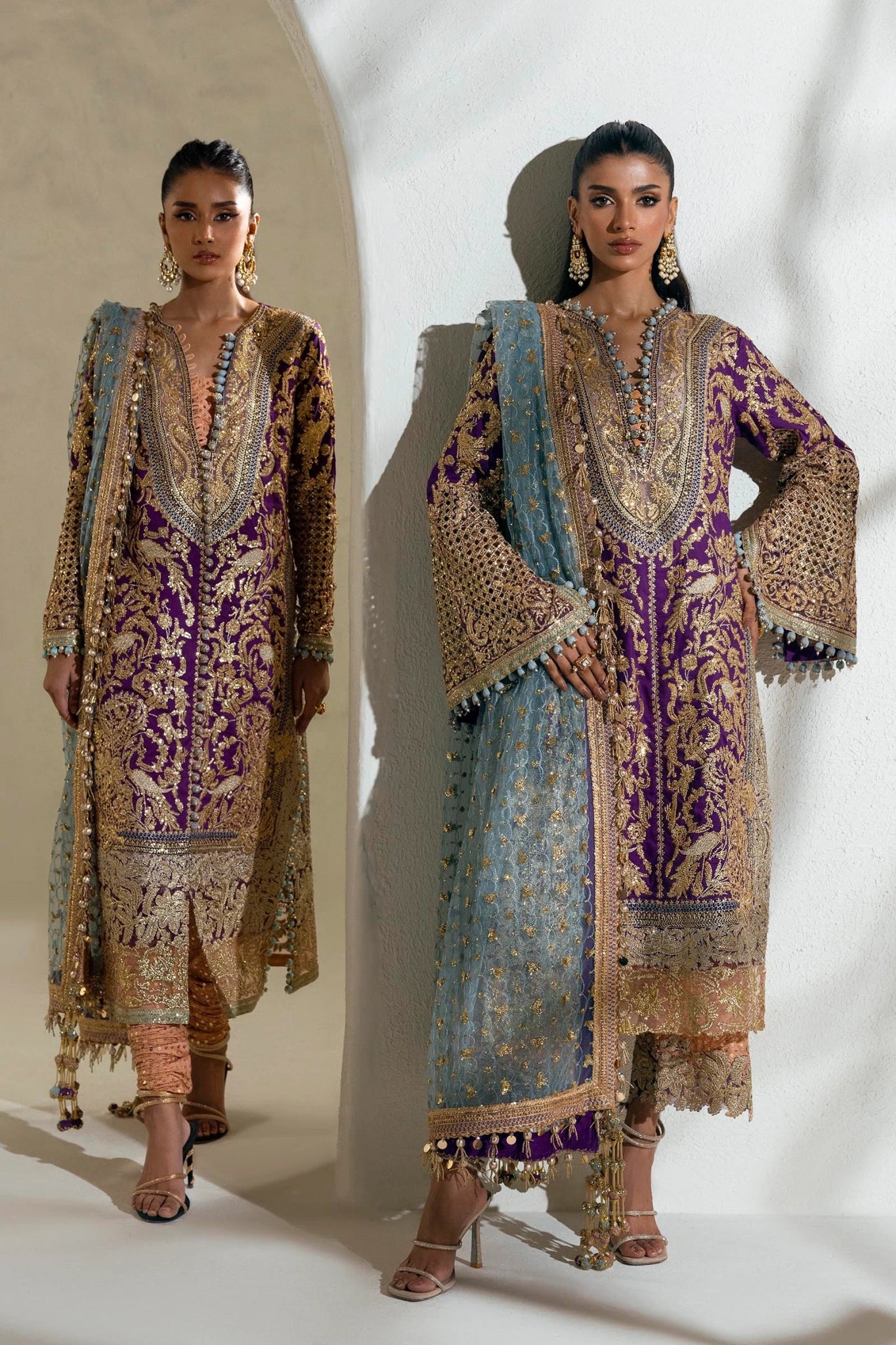 Model wearing a Sana Safinaz NURA Festive'24 Vol. II N242 - 007 - 3CX purple and gold embroidered dress with a blue dupatta. Perfect for Pakistani clothes online in UK, wedding clothes.