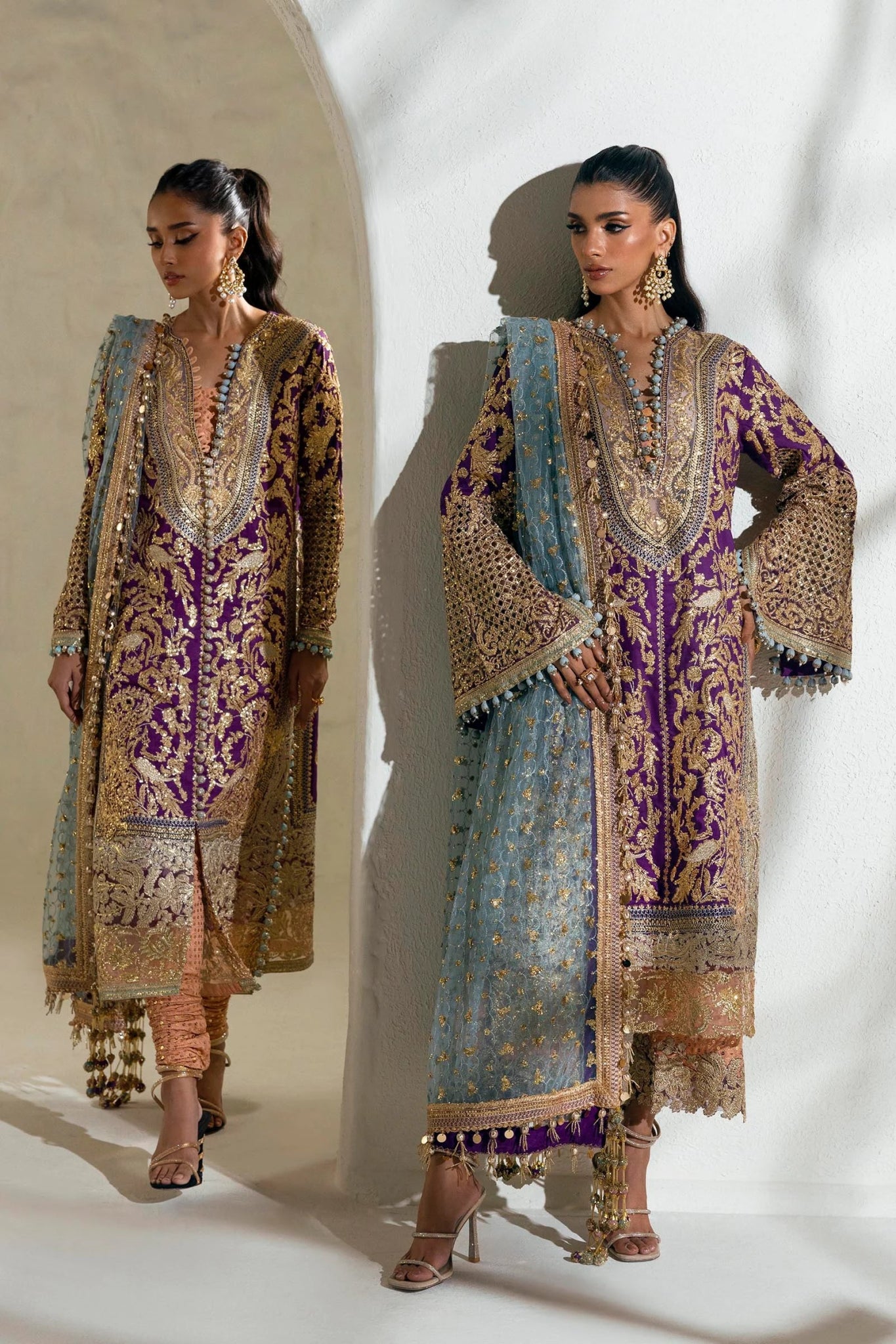 Model wearing a Sana Safinaz NURA Festive'24 Vol. II N242 - 007 - 3CX purple and gold embroidered dress with a blue dupatta. Perfect for Pakistani clothes online in UK, wedding clothes.