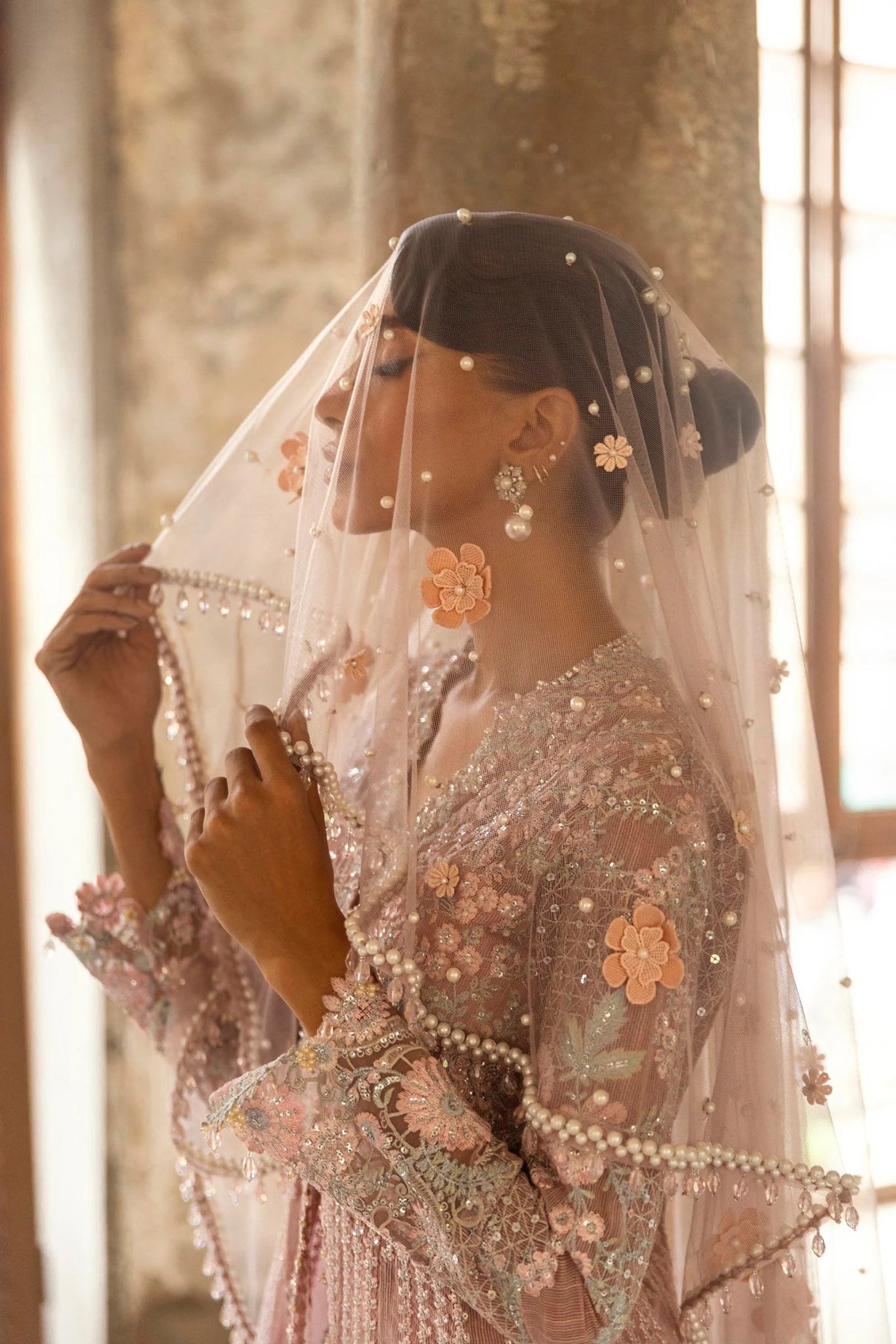 A stunning model poses in a luxurious hand - embellished lilac outfit from the Sana Safinaz Nura Vol.3 2024 collection, showcasing Pakistani fashion with intricate embroidery and luxury pret details. Available online in the UK.