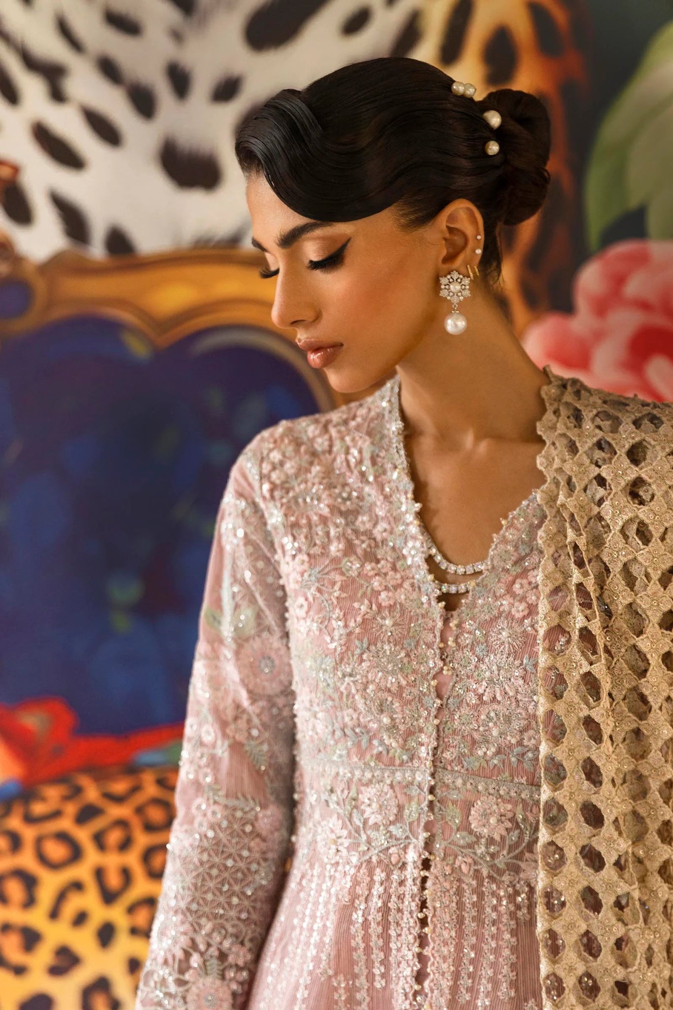 A stunning model poses in a luxurious hand - embellished lilac outfit from the Sana Safinaz Nura Vol.3 2024 collection, showcasing Pakistani fashion with intricate embroidery and luxury pret details. Available online in the UK.