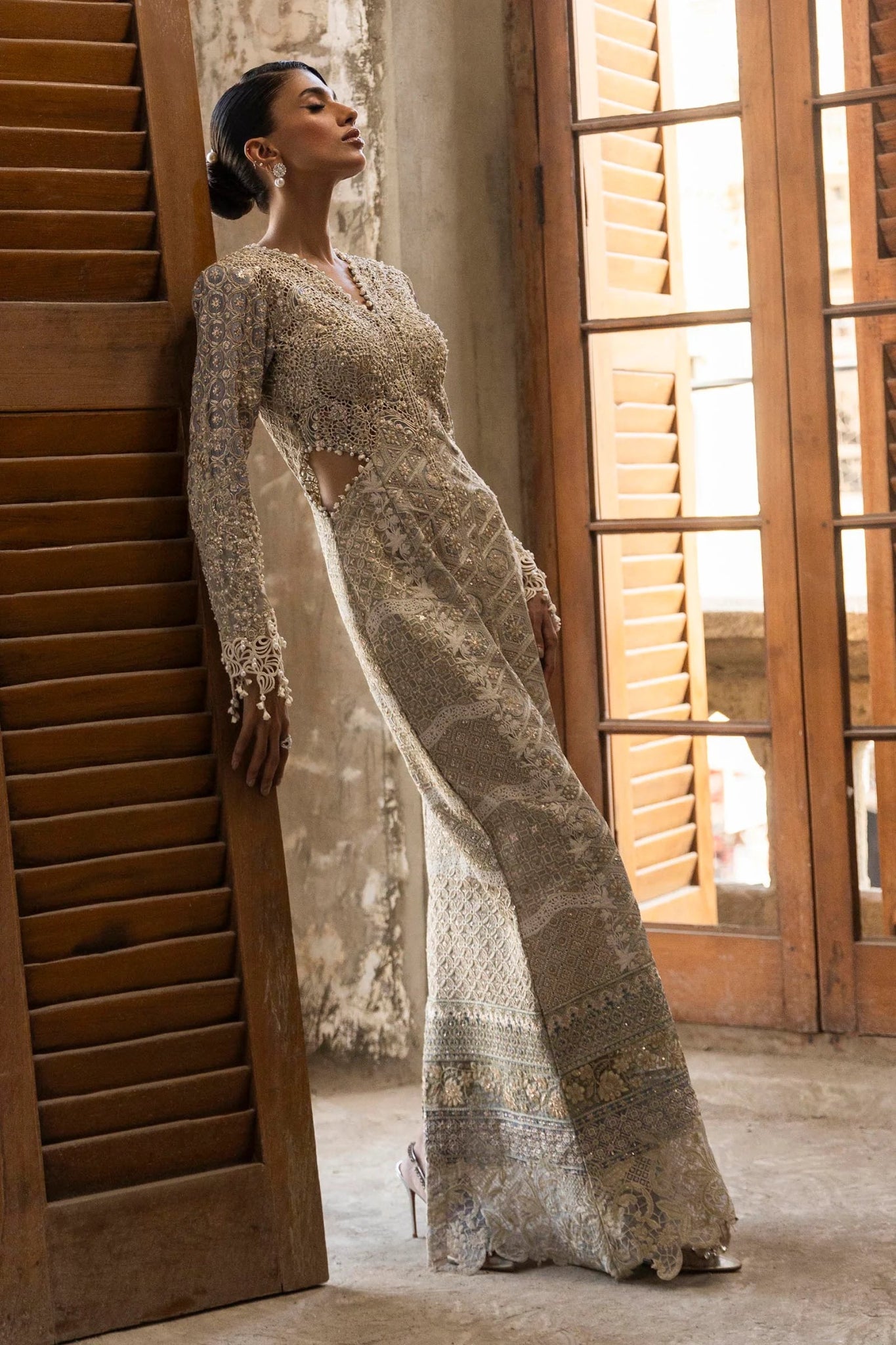 A stunning model poses in a luxurious hand - embellished lilac outfit from the Sana Safinaz Nura Vol.3 2024 collection, showcasing Pakistani fashion with intricate embroidery and luxury pret details. Available online in the UK.