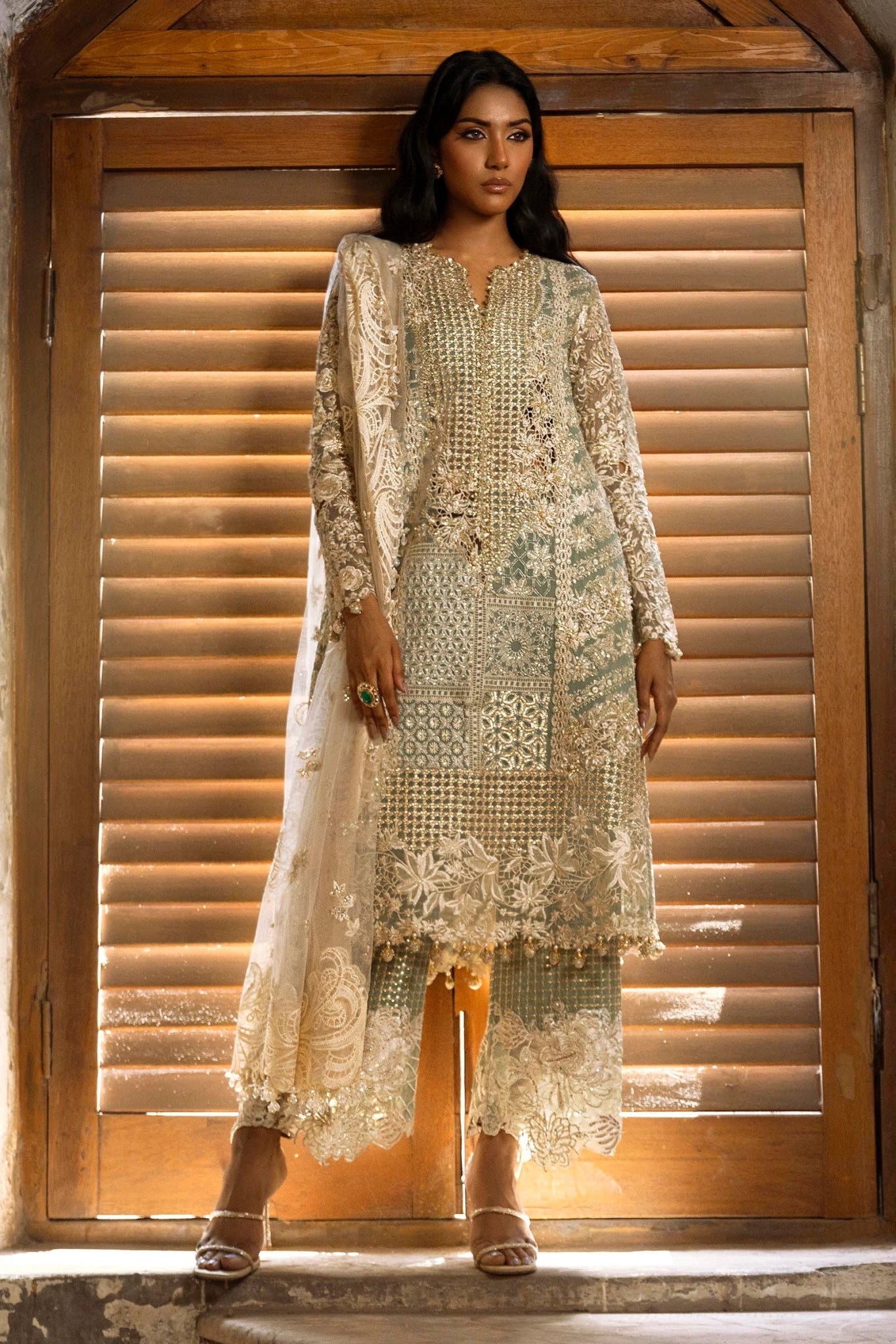 A stunning model poses in a luxurious hand - embellished lilac outfit from the Sana Safinaz Nura Vol.3 2024 collection, showcasing Pakistani fashion with intricate embroidery and luxury pret details. Available online in the UK.