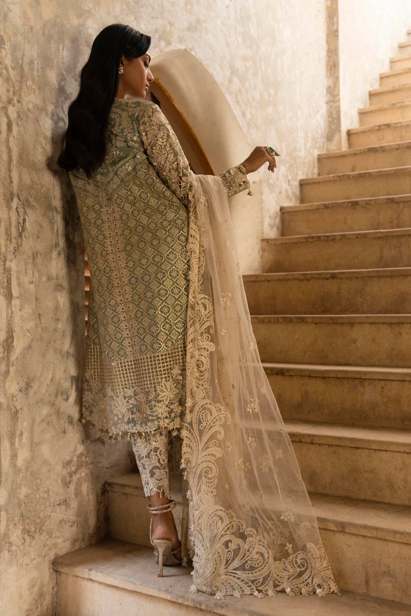 A stunning model poses in a luxurious hand - embellished lilac outfit from the Sana Safinaz Nura Vol.3 2024 collection, showcasing Pakistani fashion with intricate embroidery and luxury pret details. Available online in the UK.