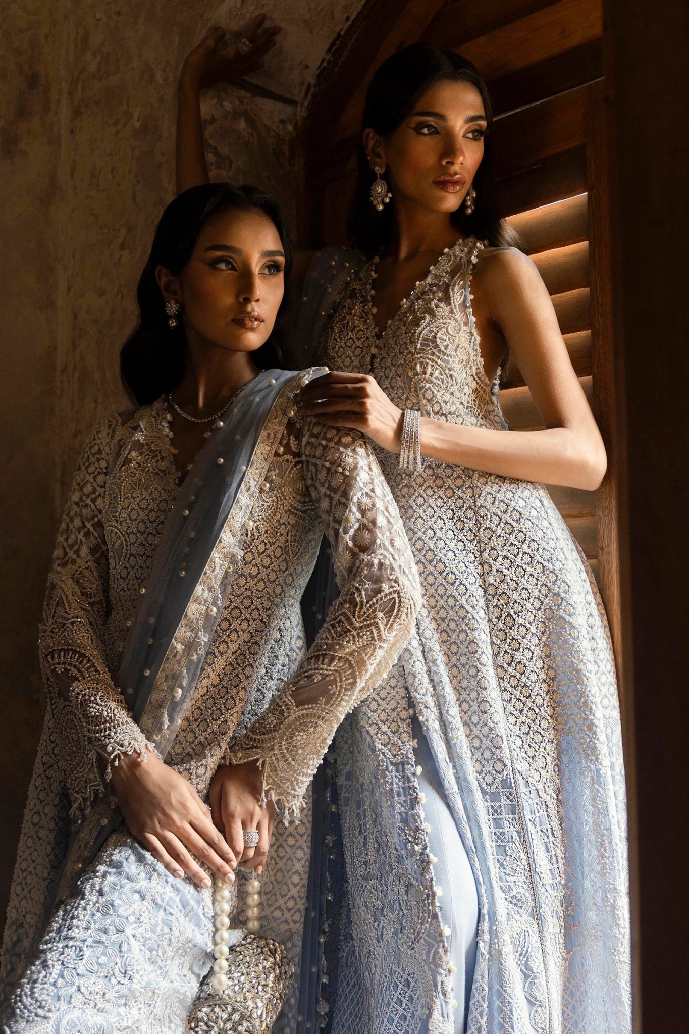 Model in a stunning Sana Safinaz Nura Vol. 3 2024 ice blue outfit featuring hand - embellished net, embroidered dupatta, and raw silk trousers. Ideal for formal events, available online in the UK.