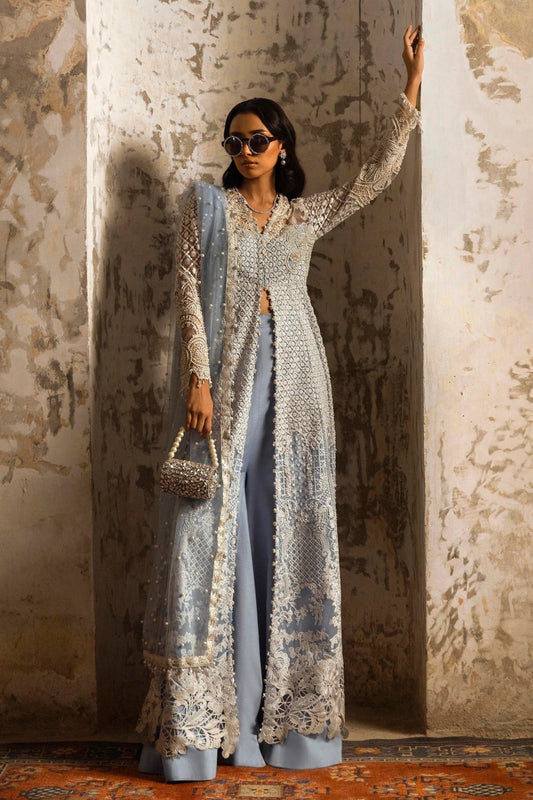 Model in a stunning Sana Safinaz Nura Vol. 3 2024 ice blue outfit featuring hand - embellished net, embroidered dupatta, and raw silk trousers. Ideal for formal events, available online in the UK.