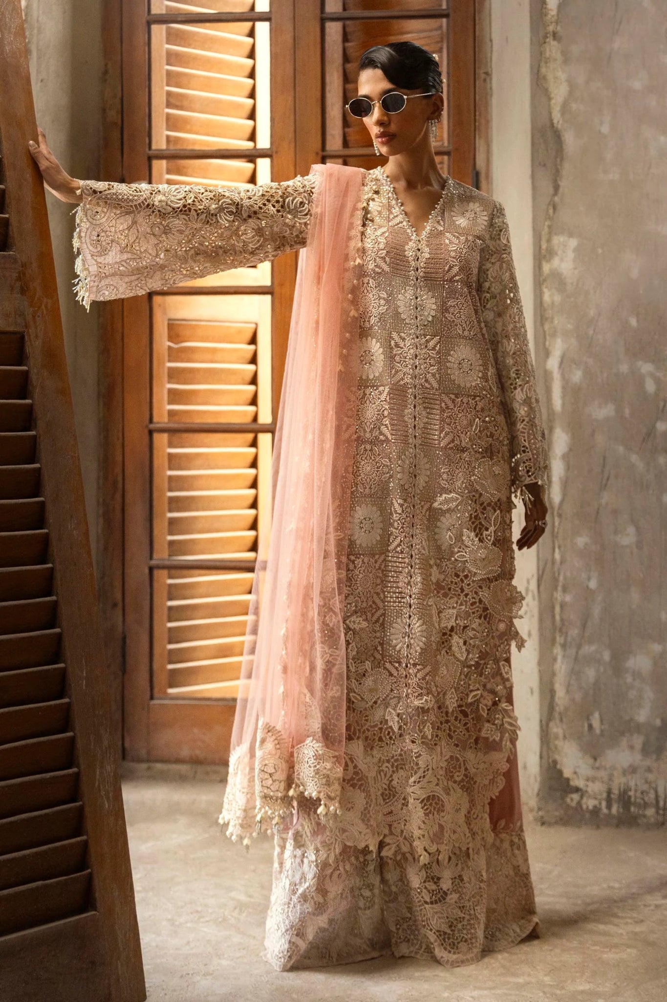 A stunning model poses in a luxurious hand - embellished lilac outfit from the Sana Safinaz Nura Vol.3 2024 collection, showcasing Pakistani fashion with intricate embroidery and luxury pret details. Available online in the UK.