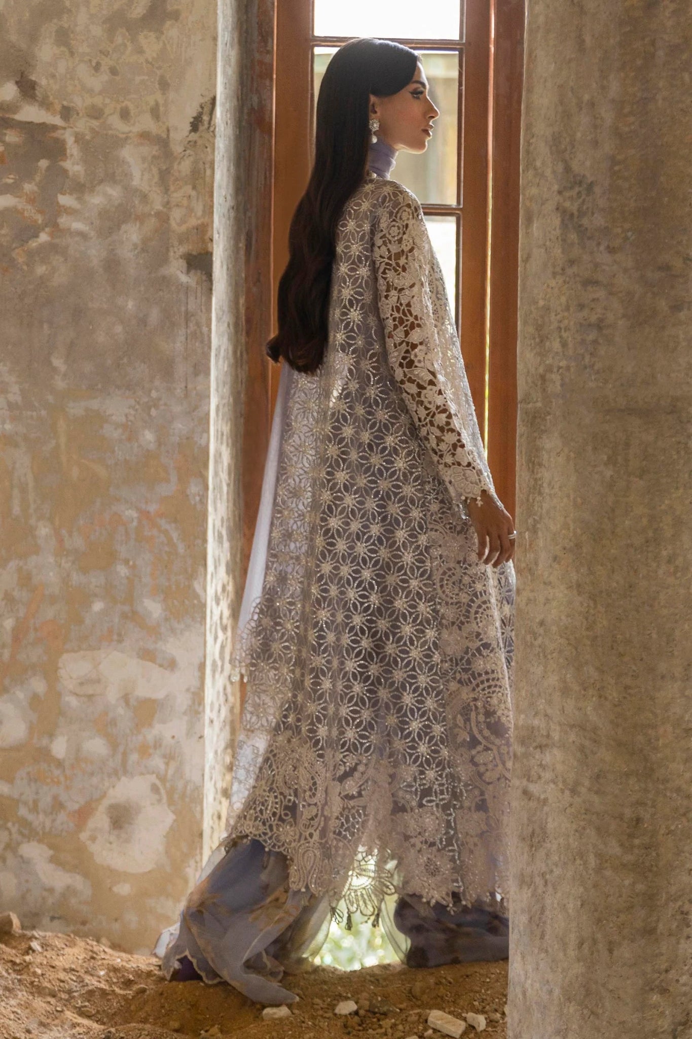 A stunning model showcasing a Sana Safinaz Nura Vol. 3 2024 lavender outfit with hand - embellished cutwork on organza, embroidered dupatta, and a digitally printed woven net lehenga. Perfect for formal occasions, this Pakistani luxury pret wear is available online in the UK exclusively at Signature Labels.