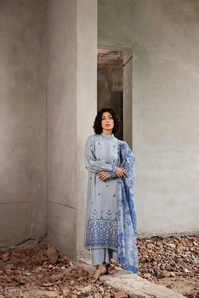 Model wearing blue and white embroidered Design 6A from Sobia Nazir's Fall Edit '24 collection. Pakistani winter clothes, casual pret available online in the UK.