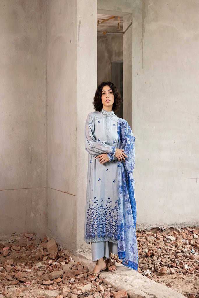 Model wearing blue and white embroidered Design 6A from Sobia Nazir's Fall Edit '24 collection. Pakistani winter clothes, casual pret available online in the UK.