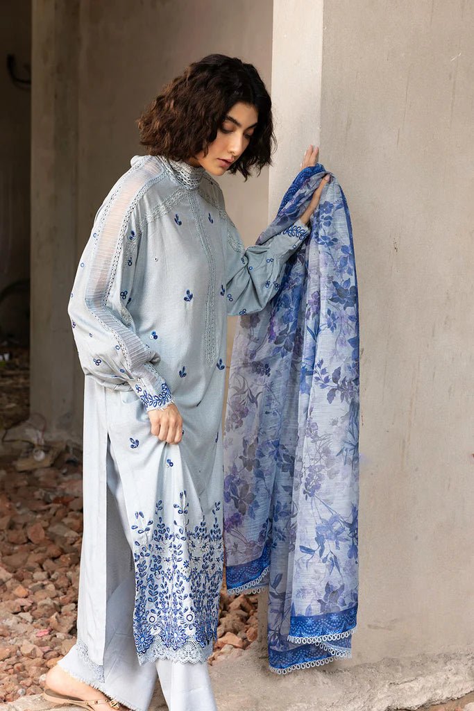 Model wearing blue and white embroidered Design 6A from Sobia Nazir's Fall Edit '24 collection. Pakistani winter clothes, casual pret available online in the UK.