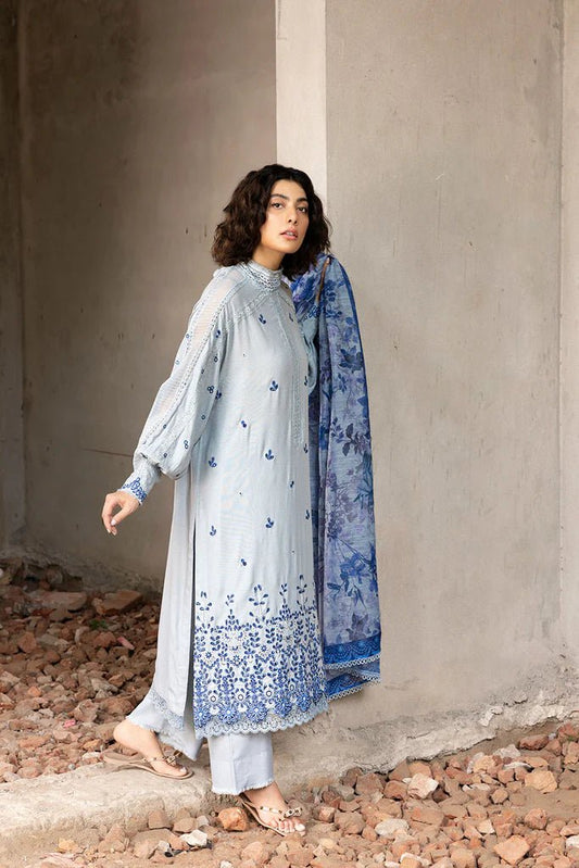 Model wearing blue and white embroidered Design 6A from Sobia Nazir's Fall Edit '24 collection. Pakistani winter clothes, casual pret available online in the UK.