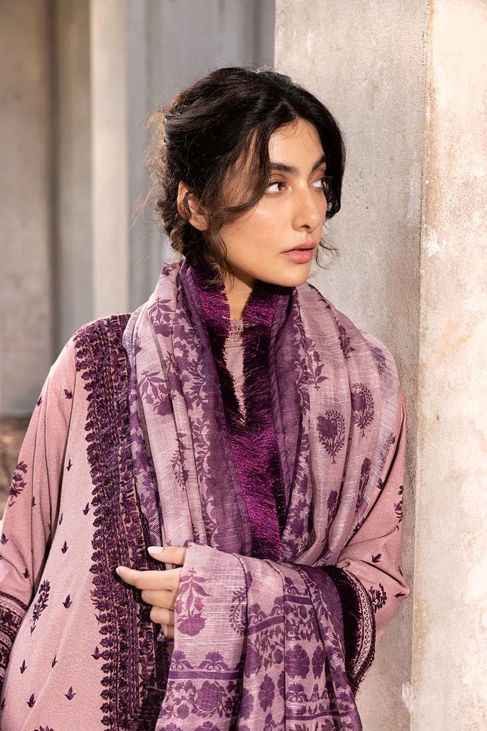 Model wearing Sobia Nazir Fall Edit '24 Design 7B, featuring a purple outfit with intricate embroidery, perfect for winter casual pret. Available online in the UK.