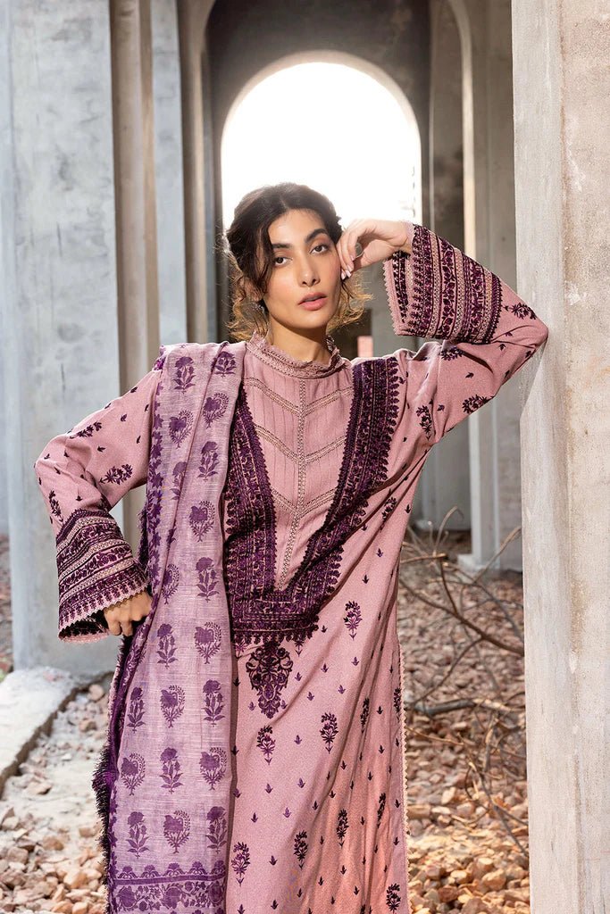 Model wearing Sobia Nazir Fall Edit '24 Design 7B, featuring a purple outfit with intricate embroidery, perfect for winter casual pret. Available online in the UK.