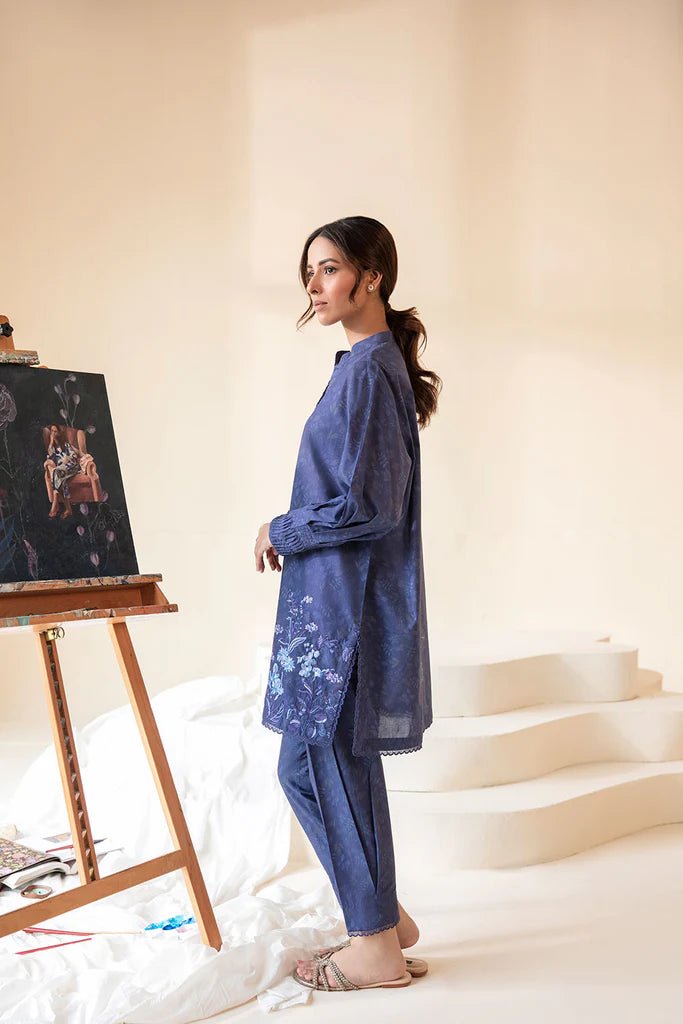 Model wearing Sobia Nazir Fall Edit '24 SNPP - 0320, featuring a blue outfit with intricate embroidery, perfect for winter casual pret. Available online in the UK.