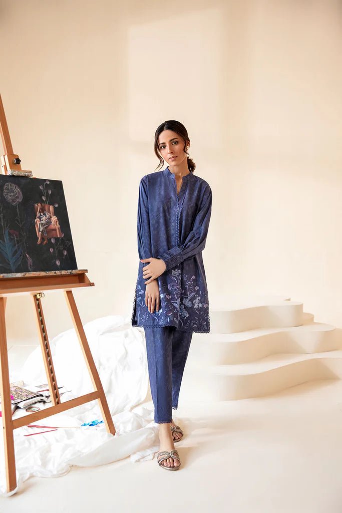 Model wearing Sobia Nazir Fall Edit '24 SNPP - 0320, featuring a blue outfit with intricate embroidery, perfect for winter casual pret. Available online in the UK.