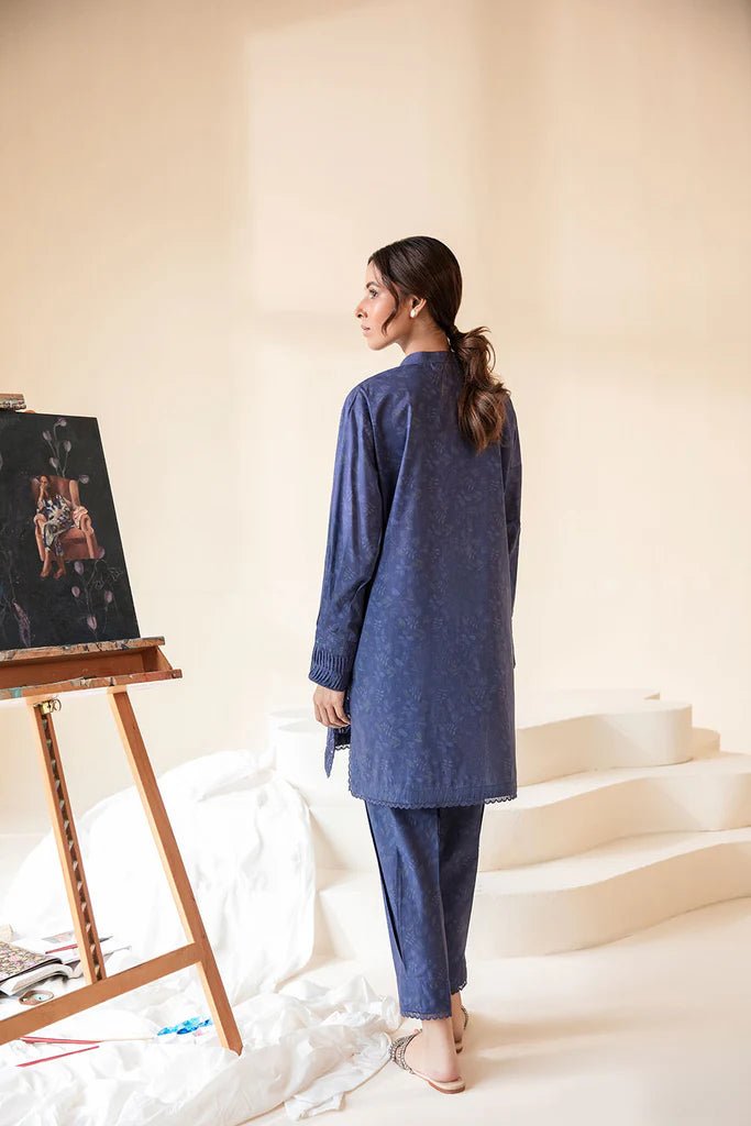 Model wearing Sobia Nazir Fall Edit '24 SNPP - 0320, featuring a blue outfit with intricate embroidery, perfect for winter casual pret. Available online in the UK.