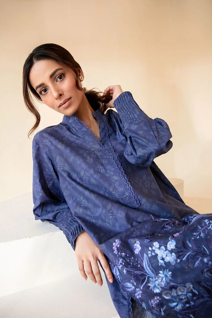 Model wearing Sobia Nazir Fall Edit '24 SNPP - 0320, featuring a blue outfit with intricate embroidery, perfect for winter casual pret. Available online in the UK.