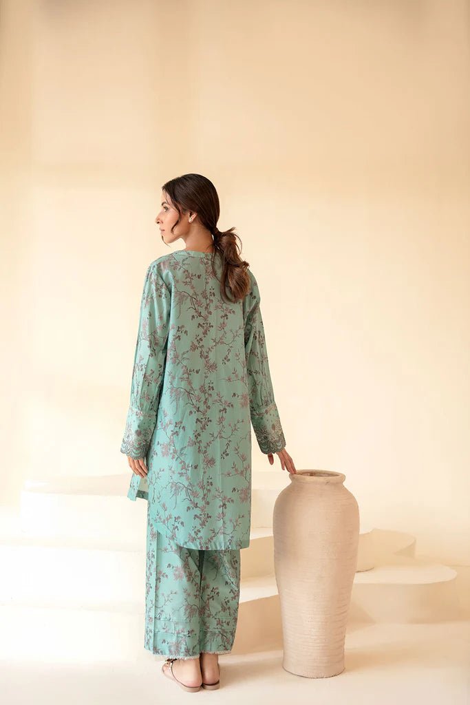 Model wearing Sobia Nazir Fall Edit '24 SNPP - 0322, showcasing a green outfit with detailed embroidery, ideal for winter casual pret. Available online in the UK.