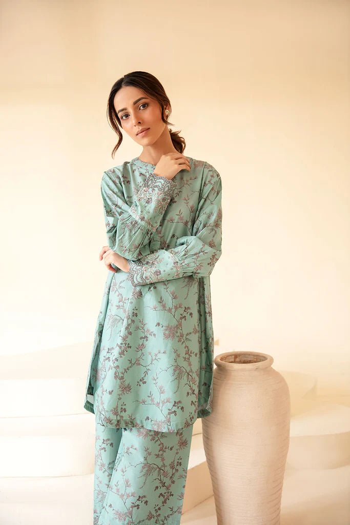 Model wearing Sobia Nazir Fall Edit '24 SNPP - 0322, showcasing a green outfit with detailed embroidery, ideal for winter casual pret. Available online in the UK.