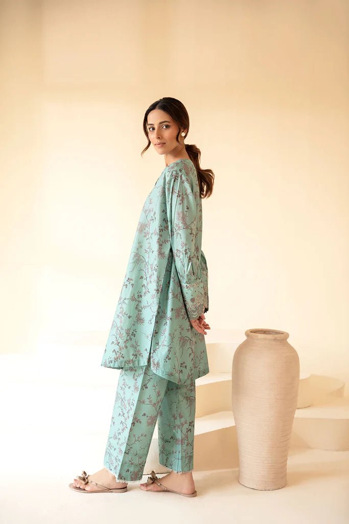 Model wearing Sobia Nazir Fall Edit '24 SNPP - 0322, showcasing a green outfit with detailed embroidery, ideal for winter casual pret. Available online in the UK.