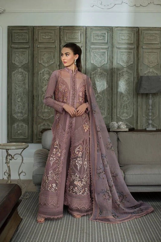 Model in Sobia Nazir DESIGN 10B, an intricate mauve Pakistani suit, showcasing UK's fine attire.