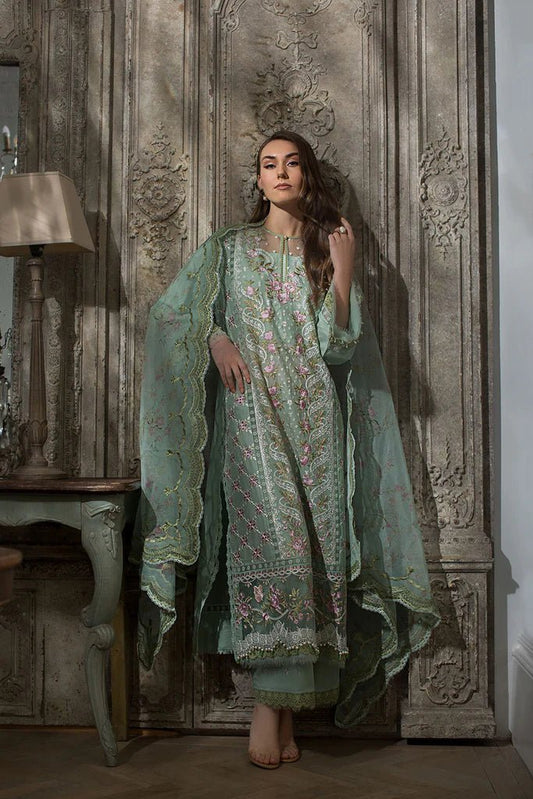 Model in Sobia Nazir DESIGN 1A, elegant green Pakistani lawn attire, sought - after in the UK.