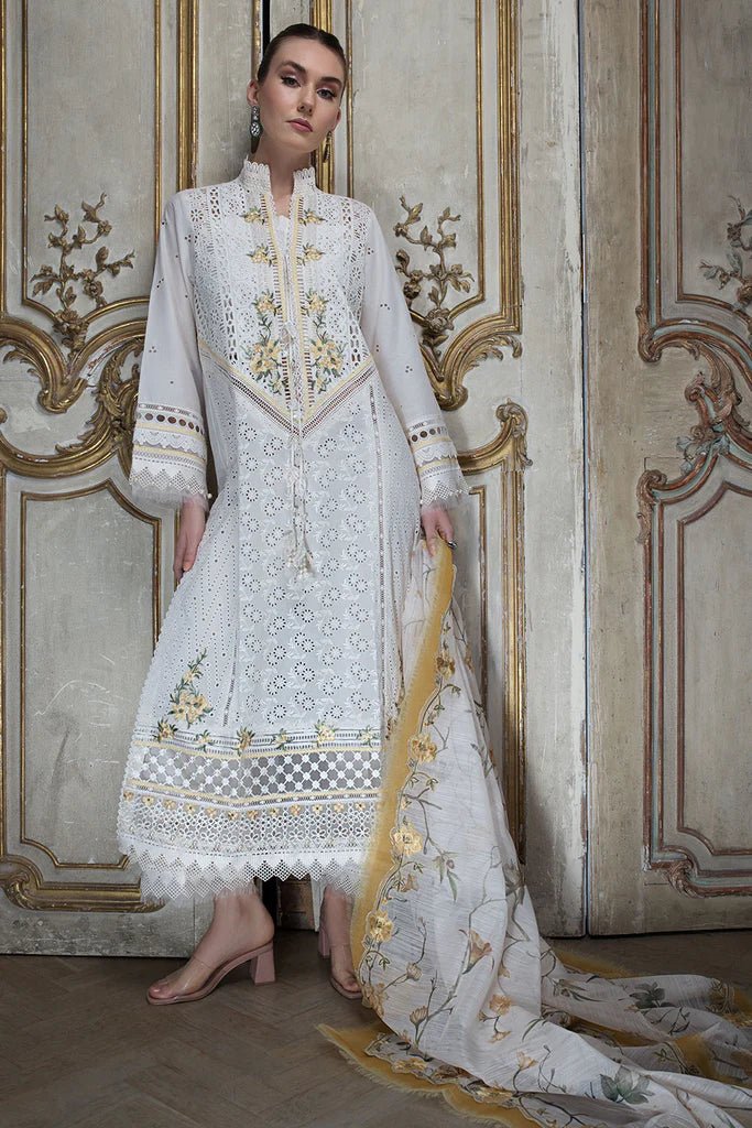 Model in Sobia Nazir DESIGN 3A, white luxury lawn attire, UK's Pakistani trend.