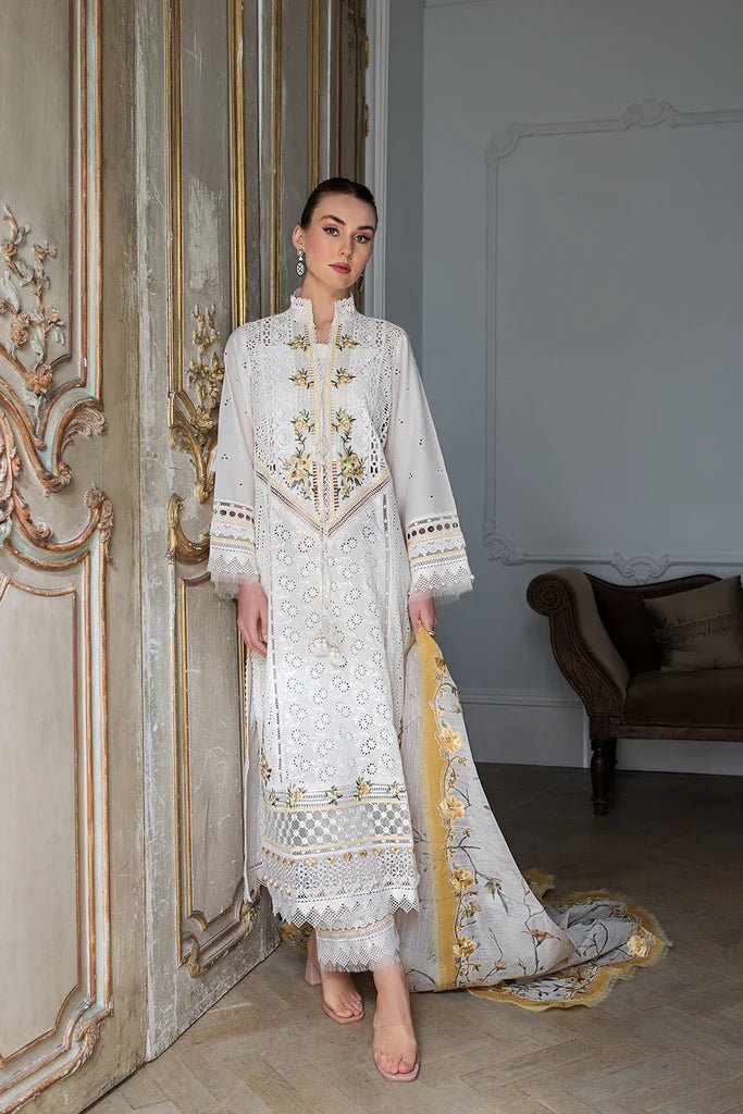 Model in Sobia Nazir DESIGN 3A, white luxury lawn attire, UK's Pakistani trend.