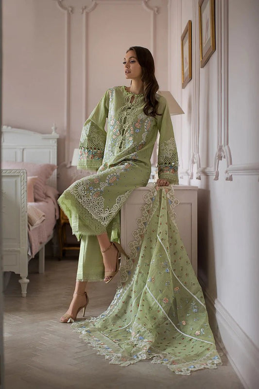 Model poses in Sobia Nazir DESIGN 4A, delicate green lawn suit, UK's Pakistani clothing choice.